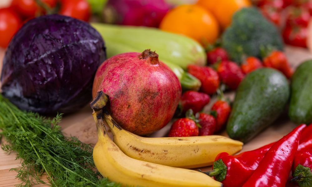 Fresh fruit and vegetables on a wooden board